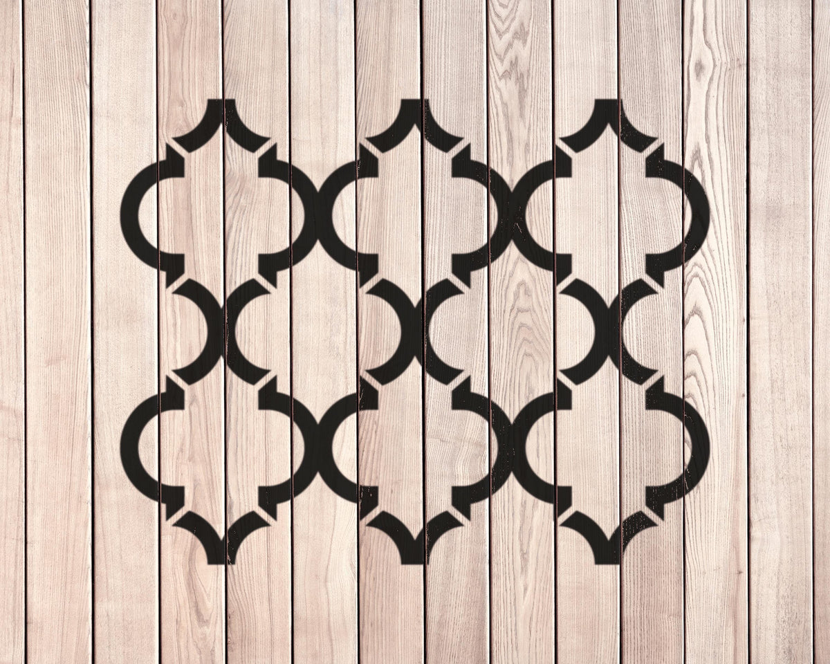 a wooden surface with a repeating pattern of black geometric shapes, creating a visually striking and symmetrical design.