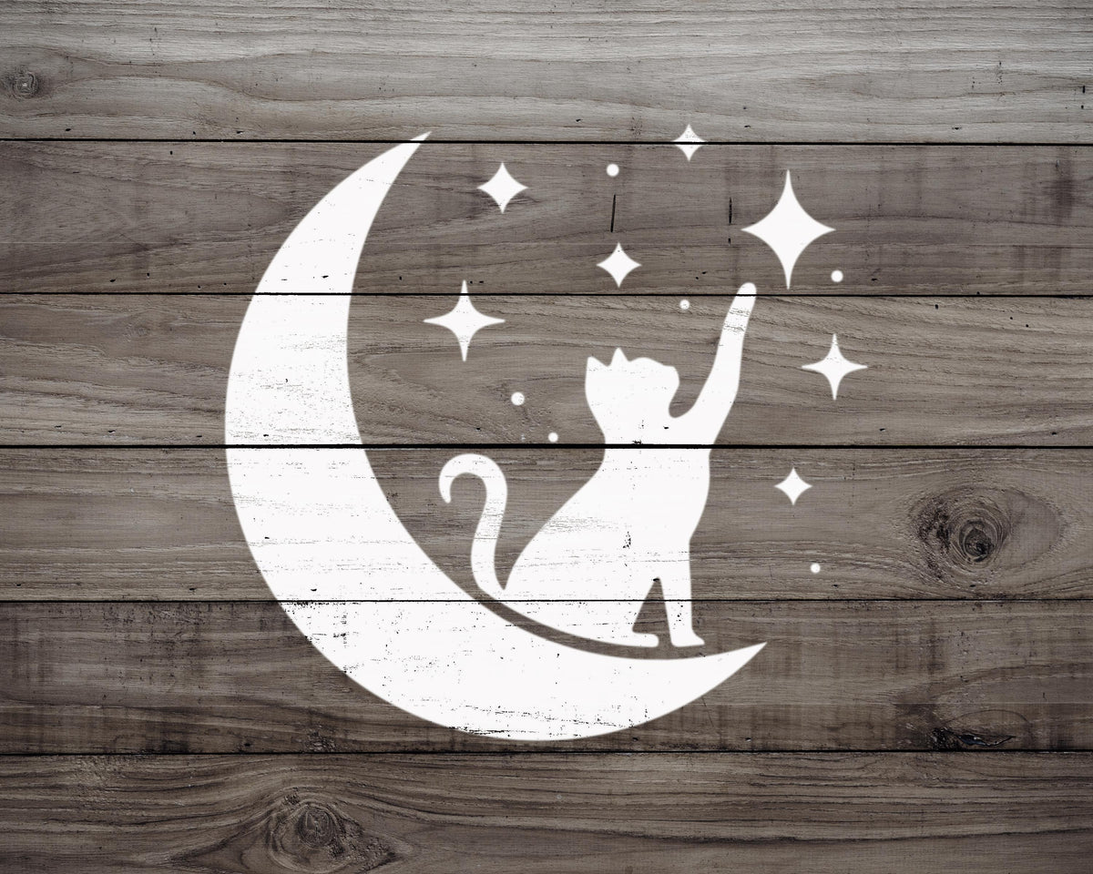 A silhouetted cat sitting on a crescent moon, with stars scattered around it, against a wooden background.