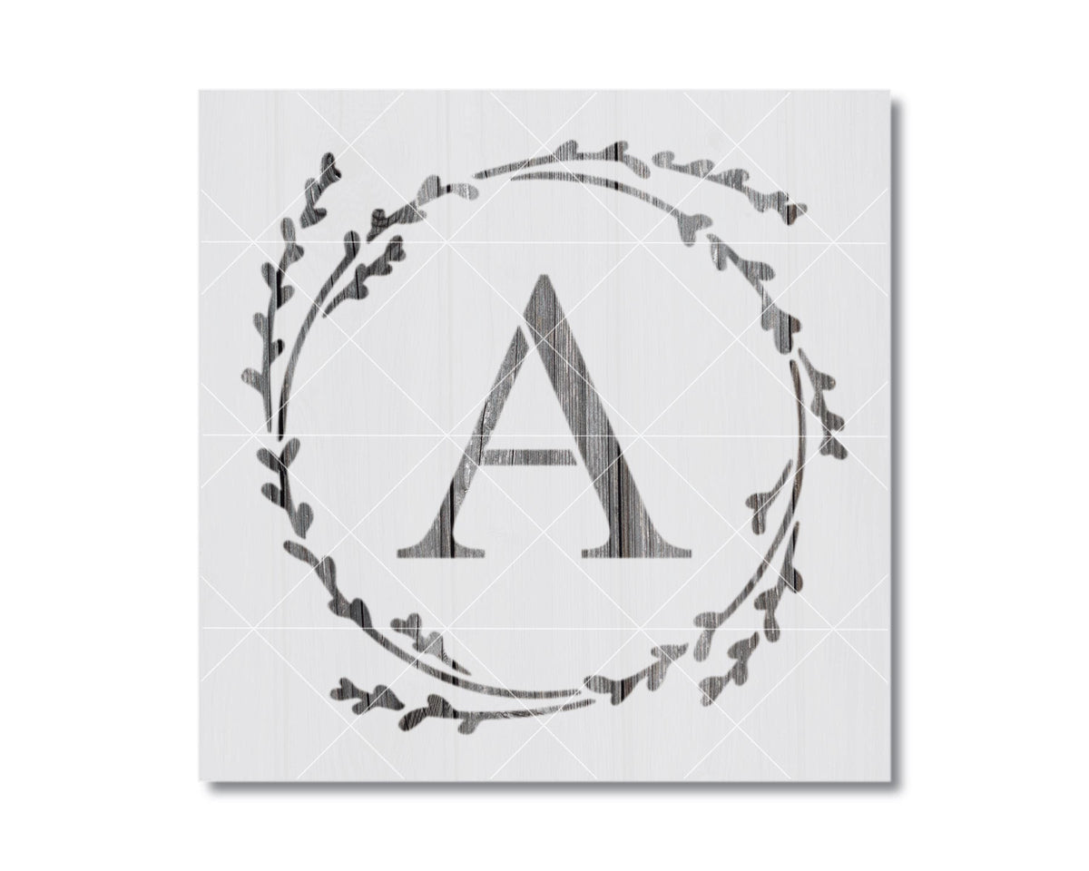 A monochromatic image featuring a stylized letter 'A' surrounded by a wreath-like design composed of small leaf-like shapes.