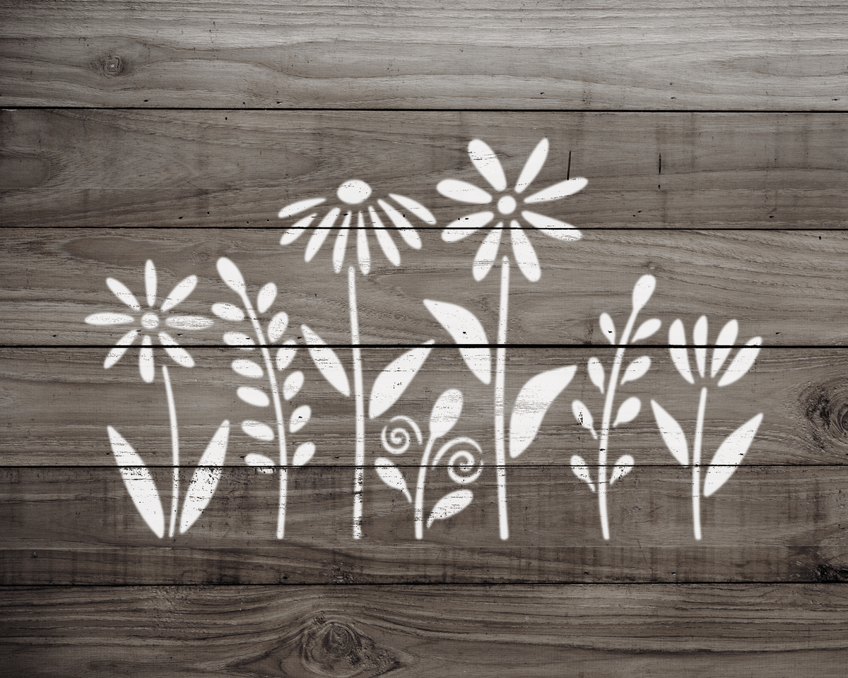 A wooden surface with white floral designs painted on it.