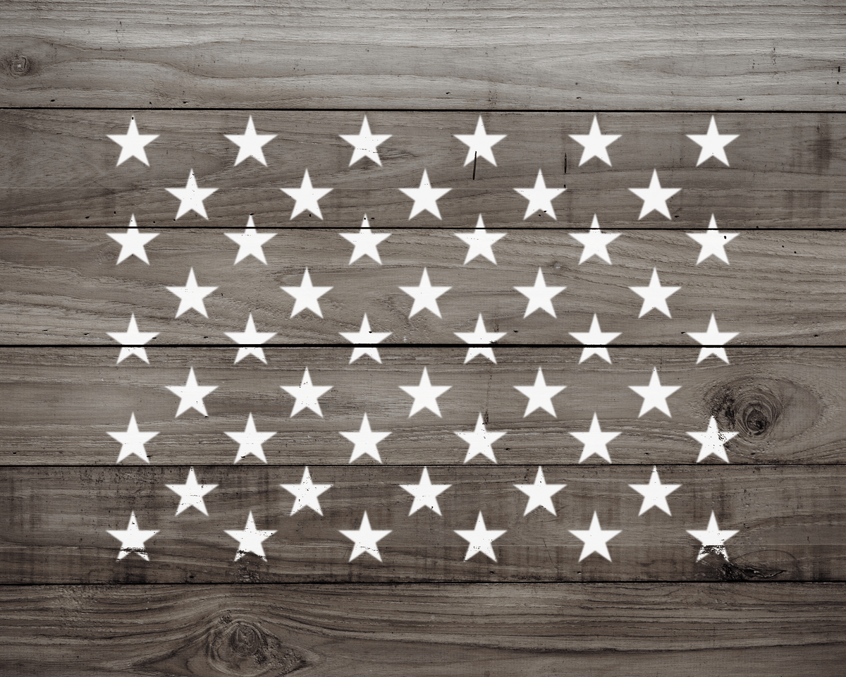 a wooden surface with a pattern of white stars arranged in a grid-like design.