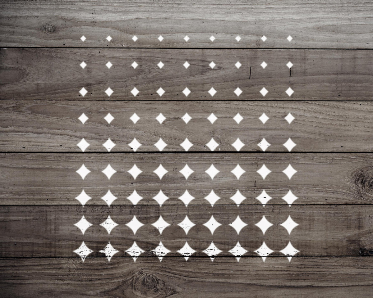 a wooden surface with a repeating pattern of white diamond shapes, creating a visually striking and geometric design.