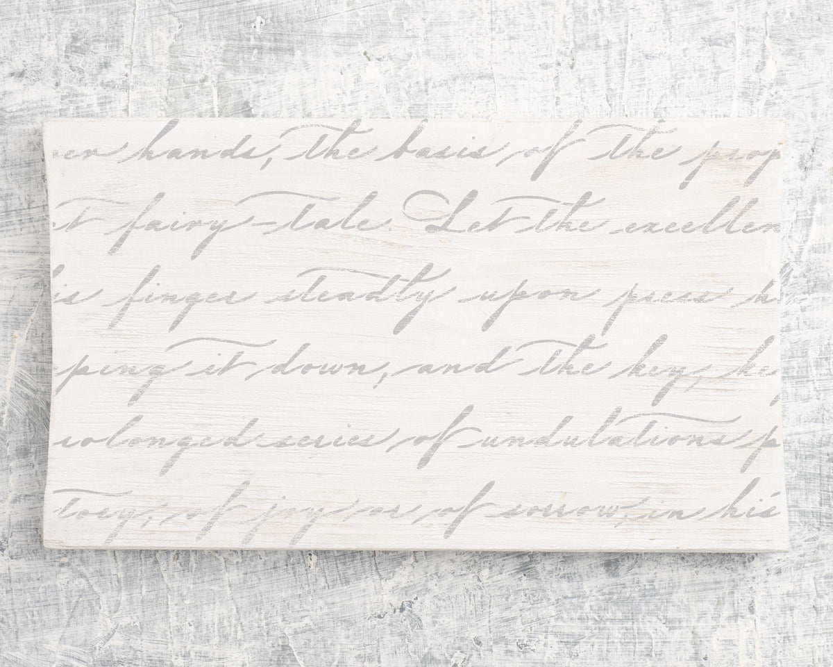 handwritten text in a cursive script style, which appears to be a piece of paper or a sign with a decorative design.