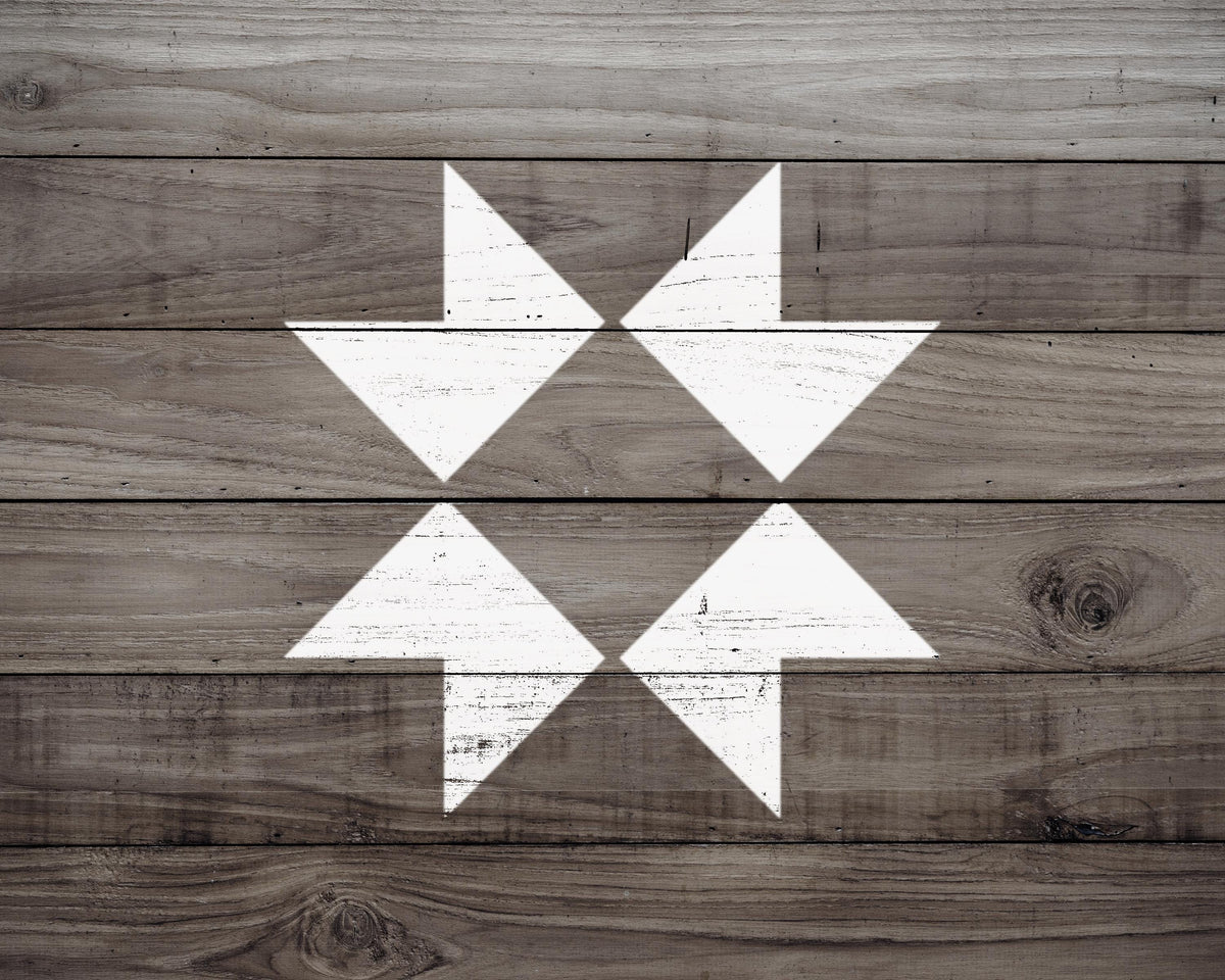 a close-up view of a wooden surface with a white arrow design in the center.