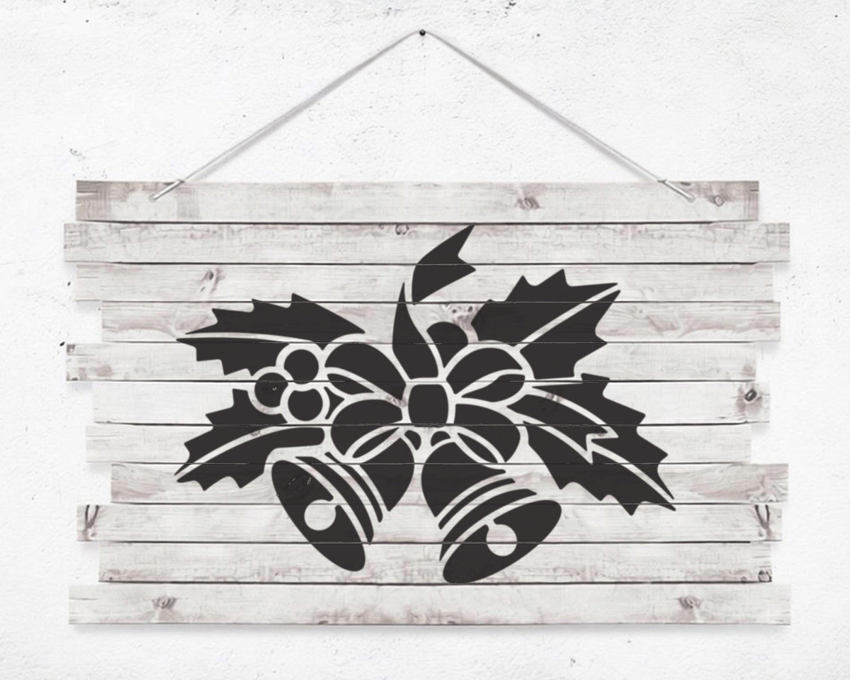A black and white image of a wooden sign with a stylized floral design featuring bells and leaves.