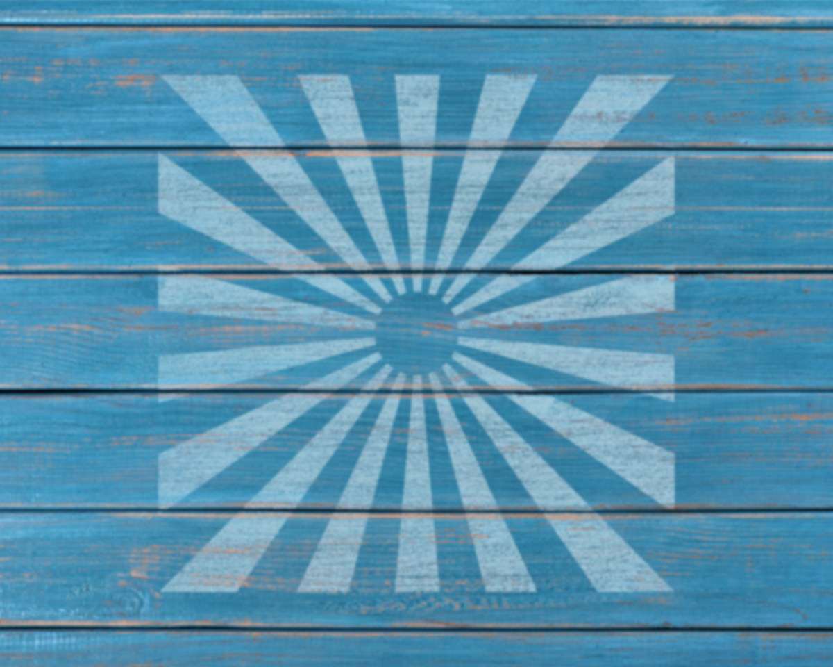 a blue wooden surface with a white sunburst design in the center.