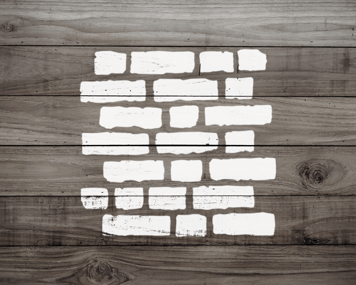 a wooden wall with white paint splatters arranged in a brick pattern.