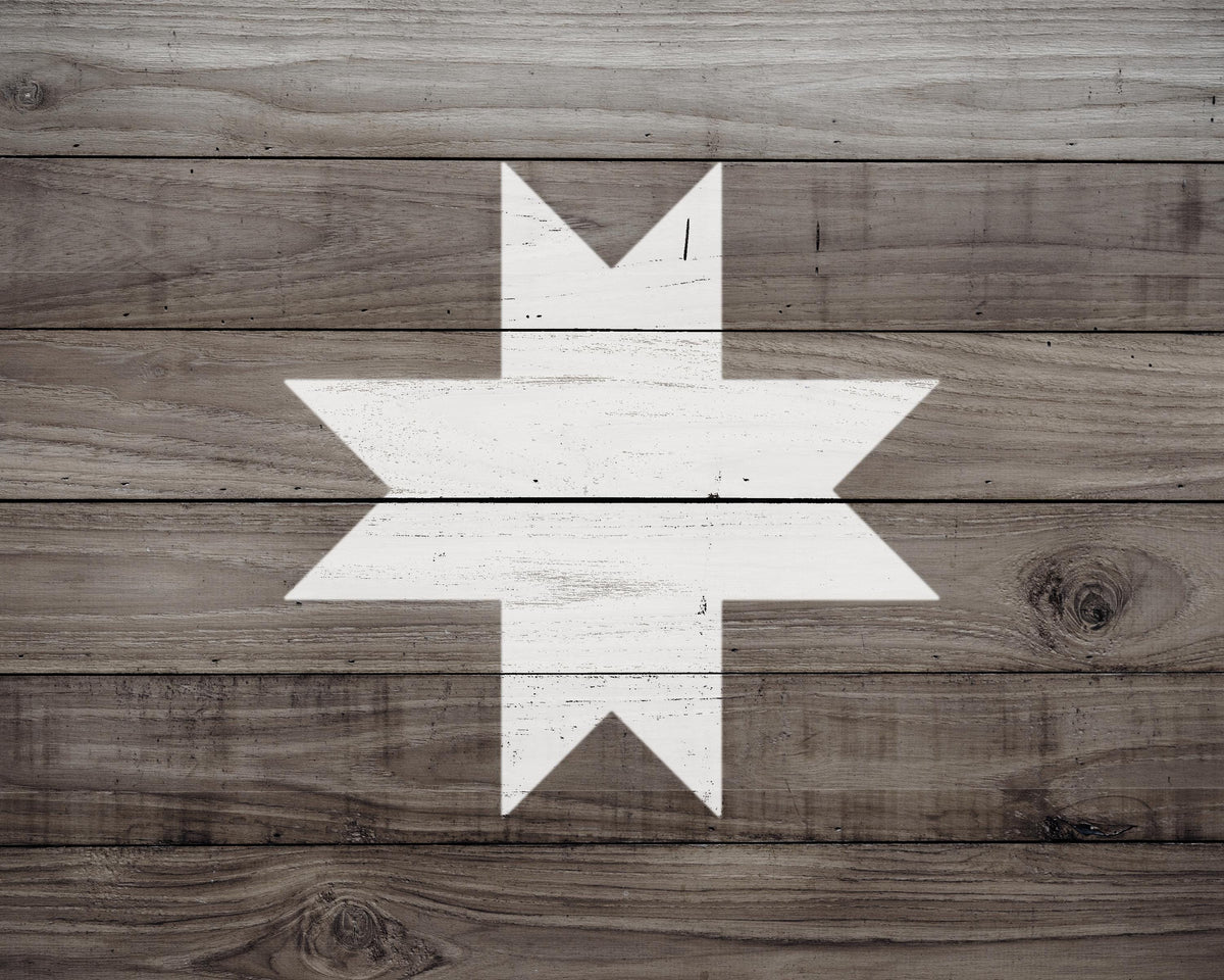 a wooden surface with a white star-shaped design in the center.