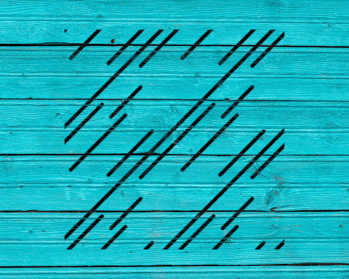 The image is a close-up of a turquoise wooden surface with a pattern of diagonal black lines.