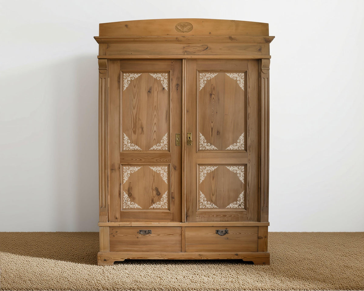 A wooden armoire with intricate carvings and two doors, standing against a white wall.