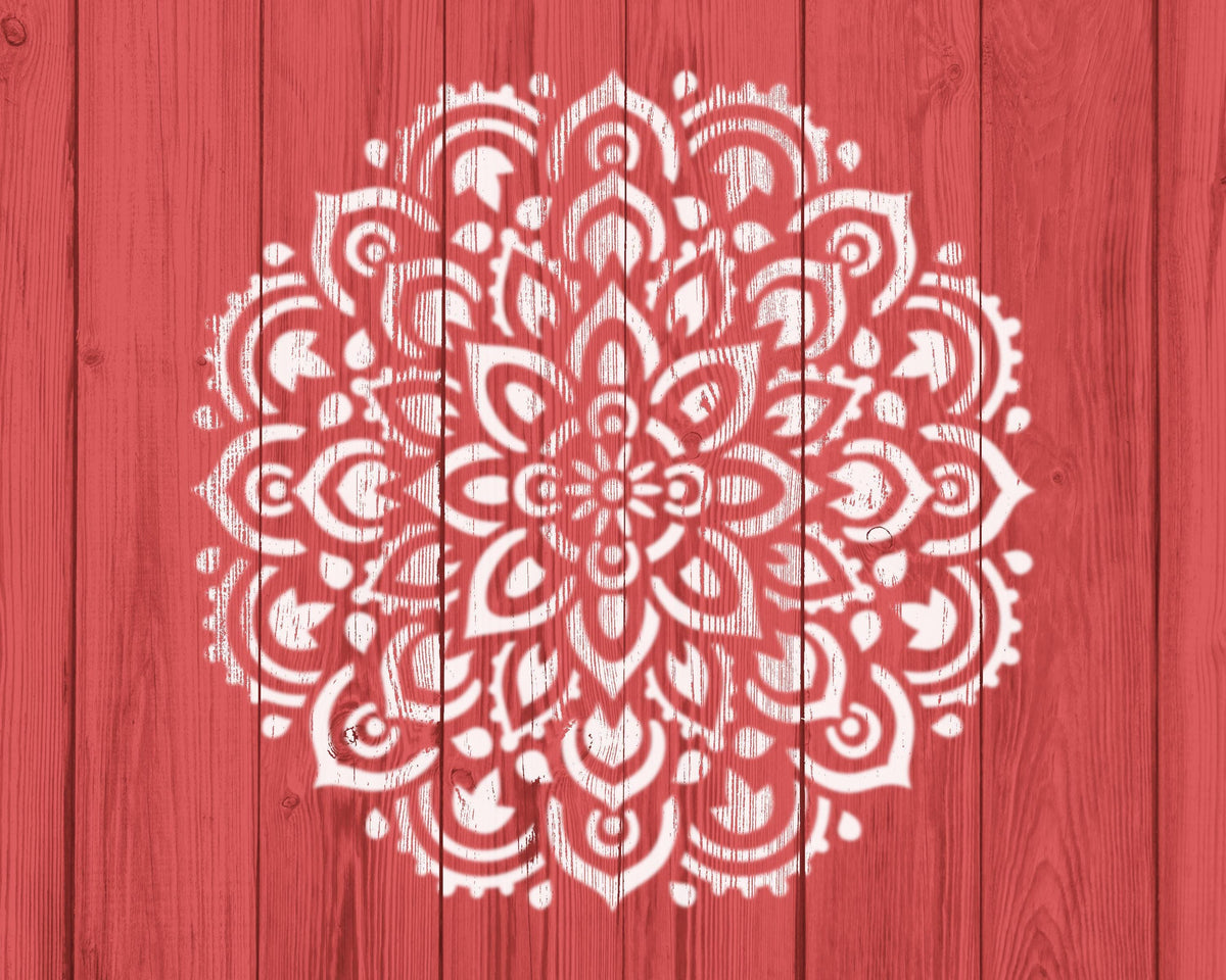 a red wooden background with a white, intricate mandala-like design painted on it.