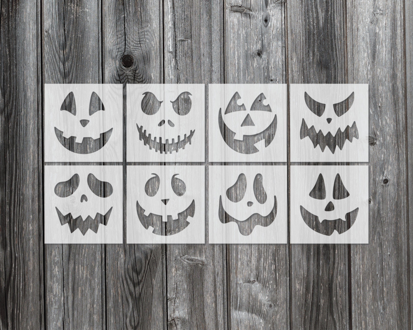a collection of nine Halloween-themed stencils displayed on a wooden background.