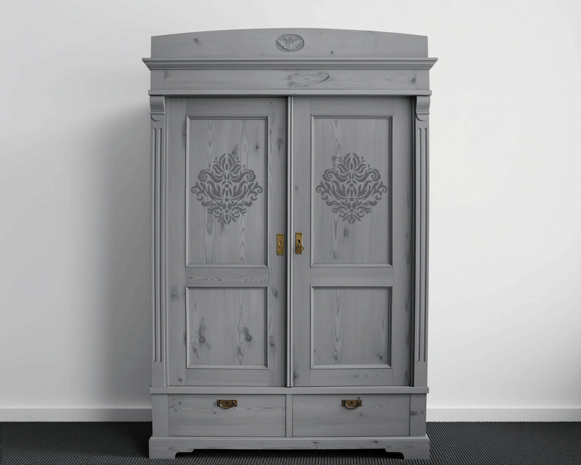 A gray wooden wardrobe with decorative elements on the doors, standing against a white wall.