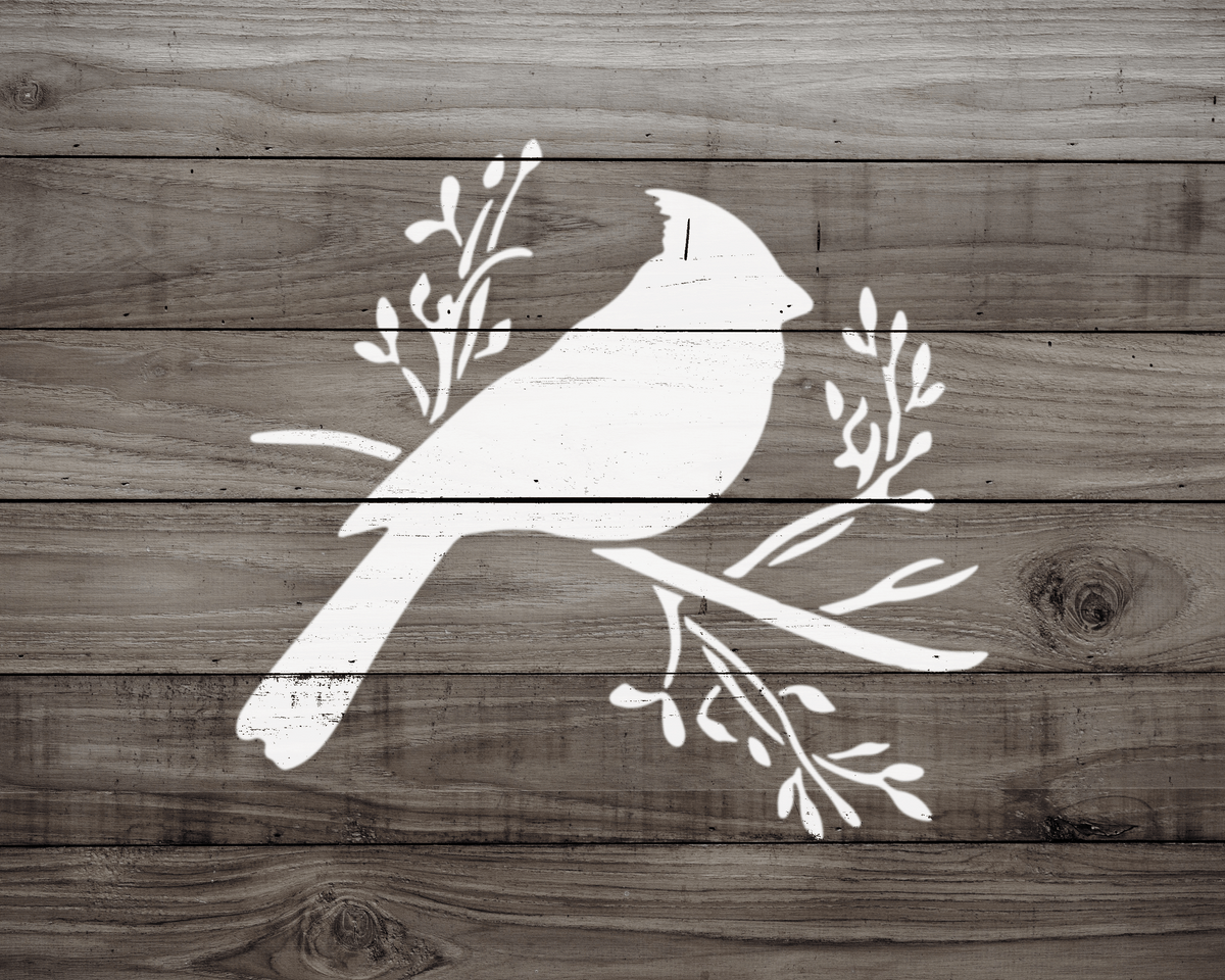 A white silhouette of a bird perched on a branch with leaves against a wooden background.