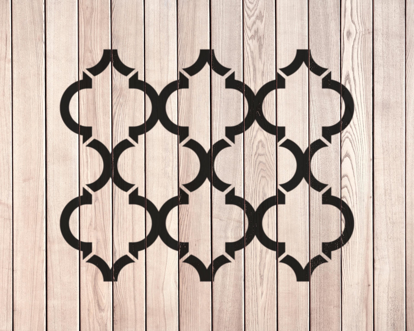 a wooden surface with a repeating pattern of black geometric shapes, creating a visually striking and symmetrical design.
