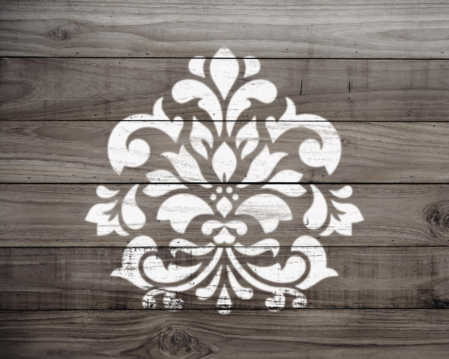 a decorative white pattern painted on a wooden surface.