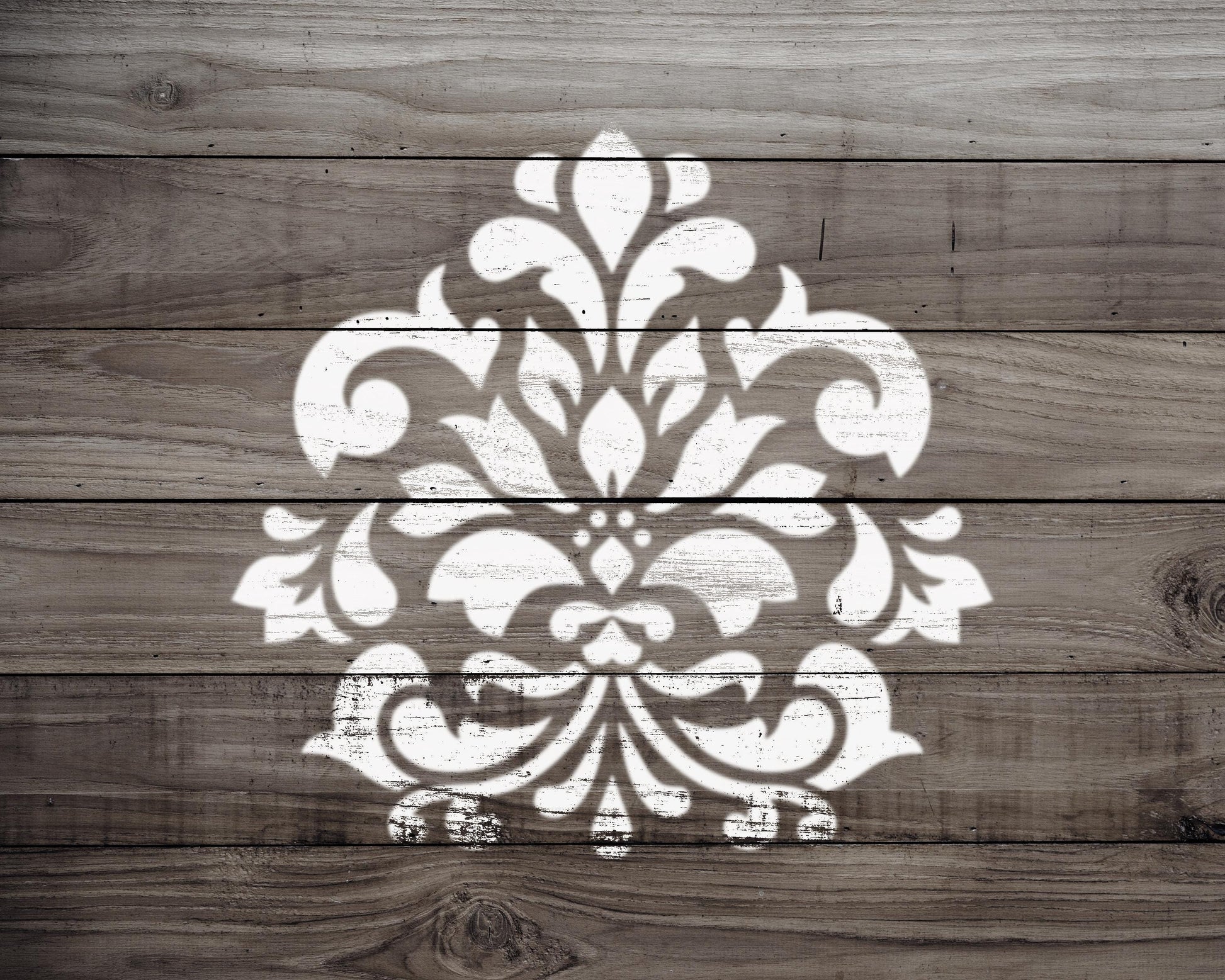a decorative white pattern painted on a wooden surface.