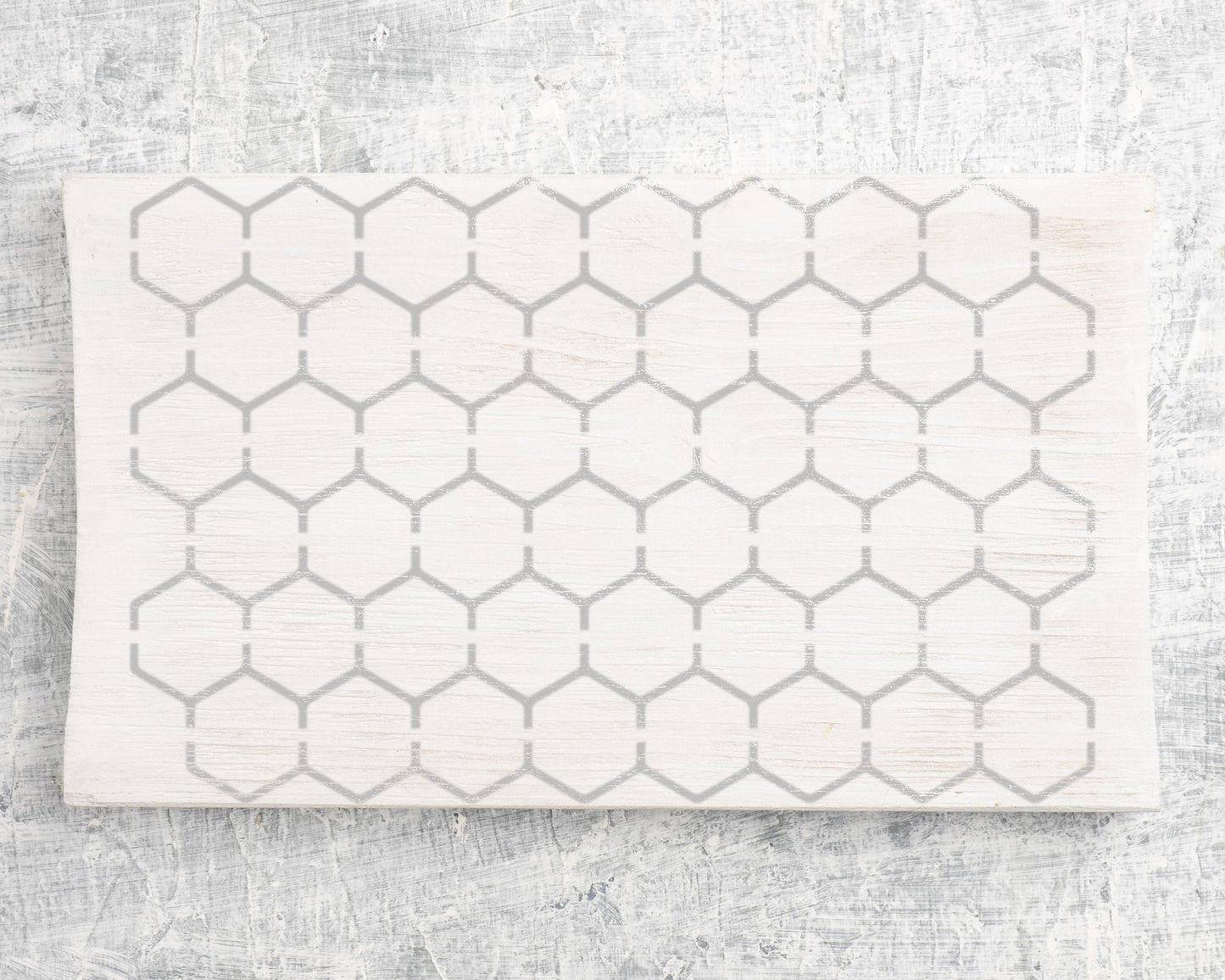 a white surface with a repeating pattern of gray hexagons.