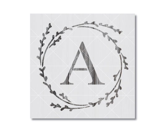 A monochromatic image featuring a stylized letter 'A' surrounded by a wreath-like design composed of small leaf-like shapes.