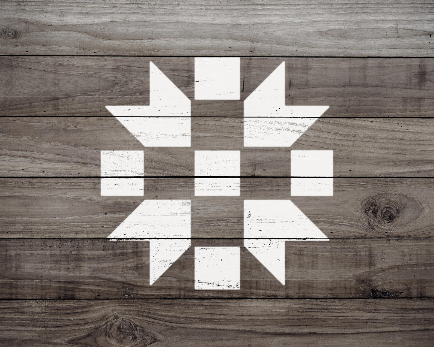 a wooden surface with a white geometric pattern, consisting of a diamond shape with smaller diamonds arranged in a circular pattern.
