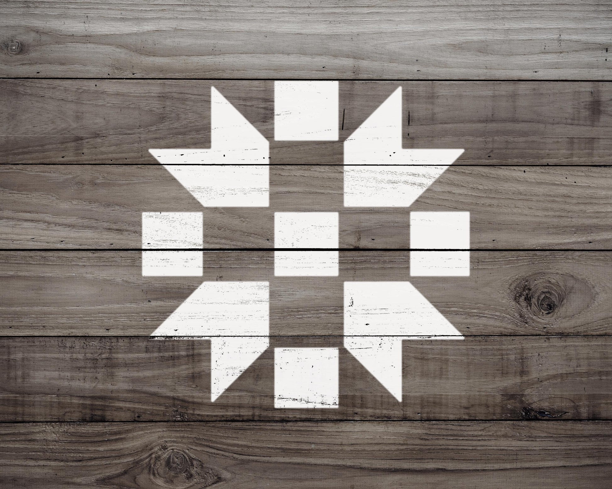 a wooden surface with a white geometric pattern, consisting of a diamond shape with smaller diamonds arranged in a circular pattern.
