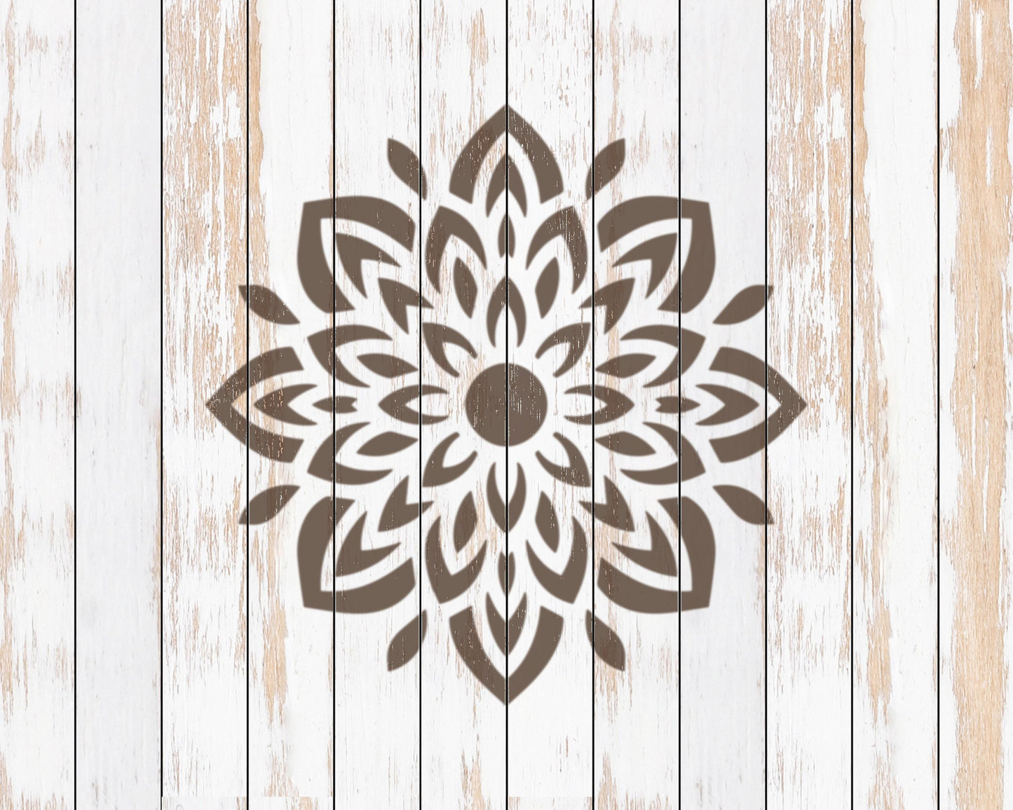 a large, intricate floral pattern in brown on a white wooden background.
