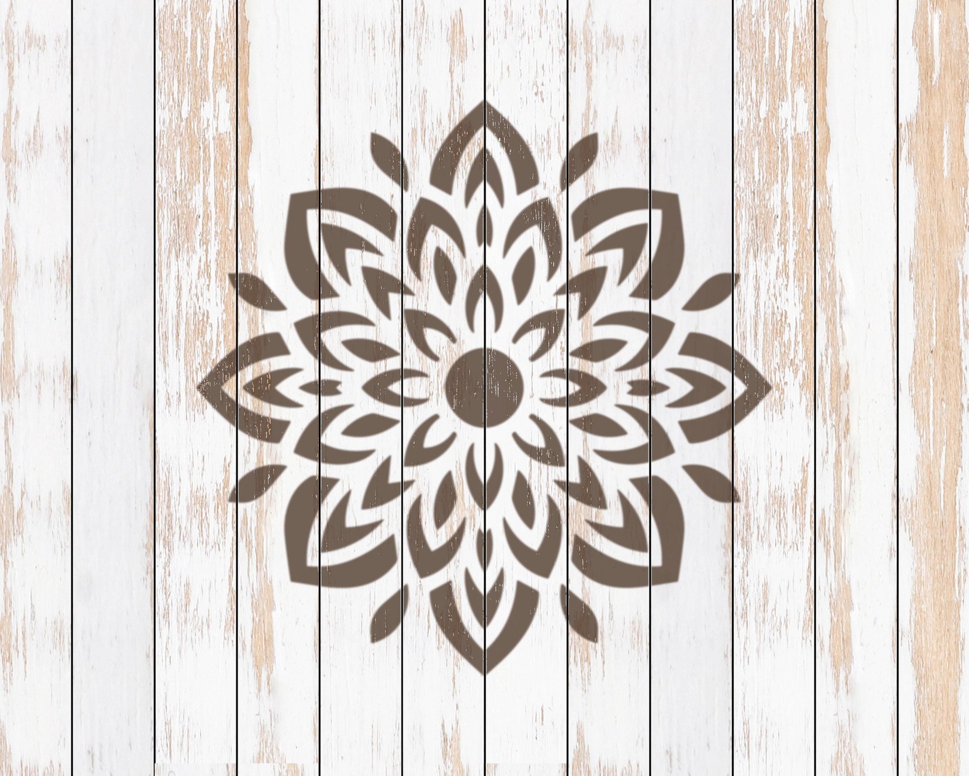 a large, intricate floral pattern in brown on a white wooden background.