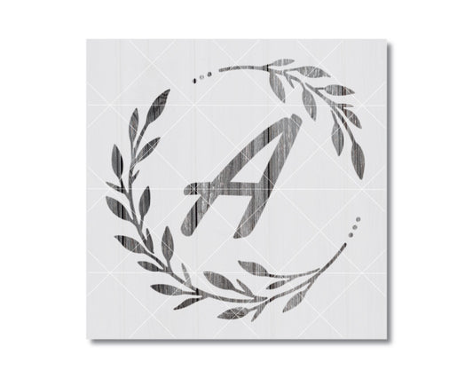 A monochromatic image featuring a stylized letter 'A' surrounded by a wreath of leaves and branches.