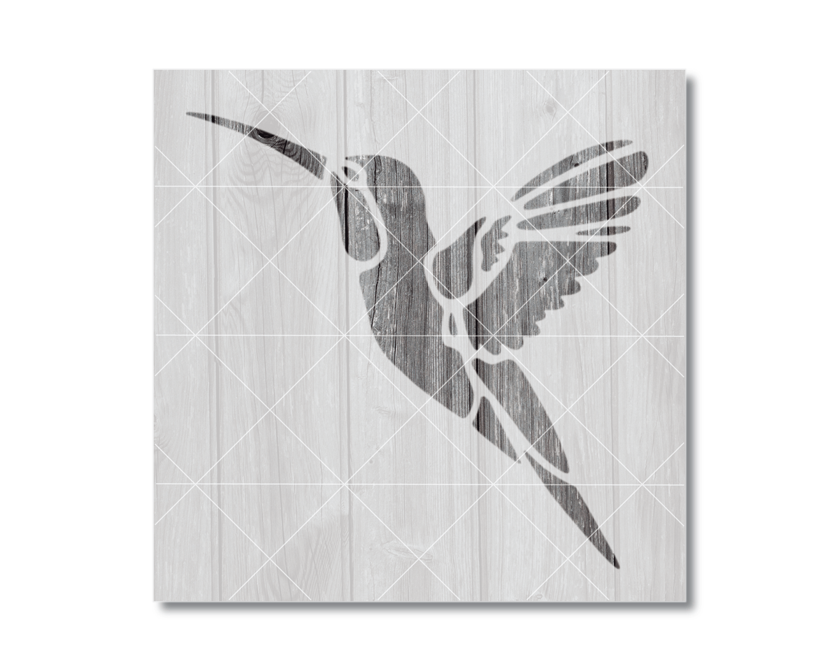 A silhouette of a hummingbird in flight against a wooden background.