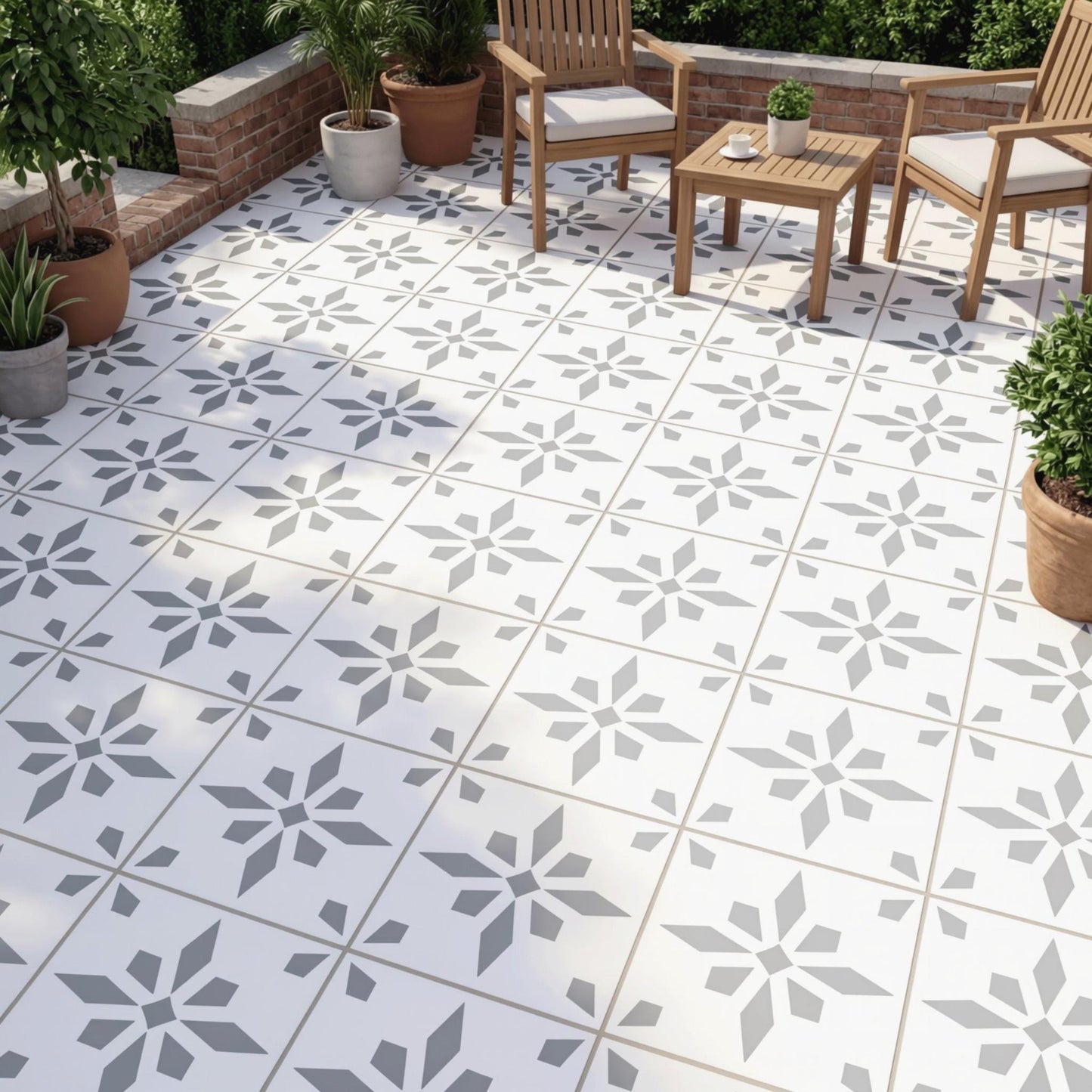 a patio area with a tile floor and wooden furniture, including chairs and a table. The patio is decorated with potted plants and has a brick wall in the background.