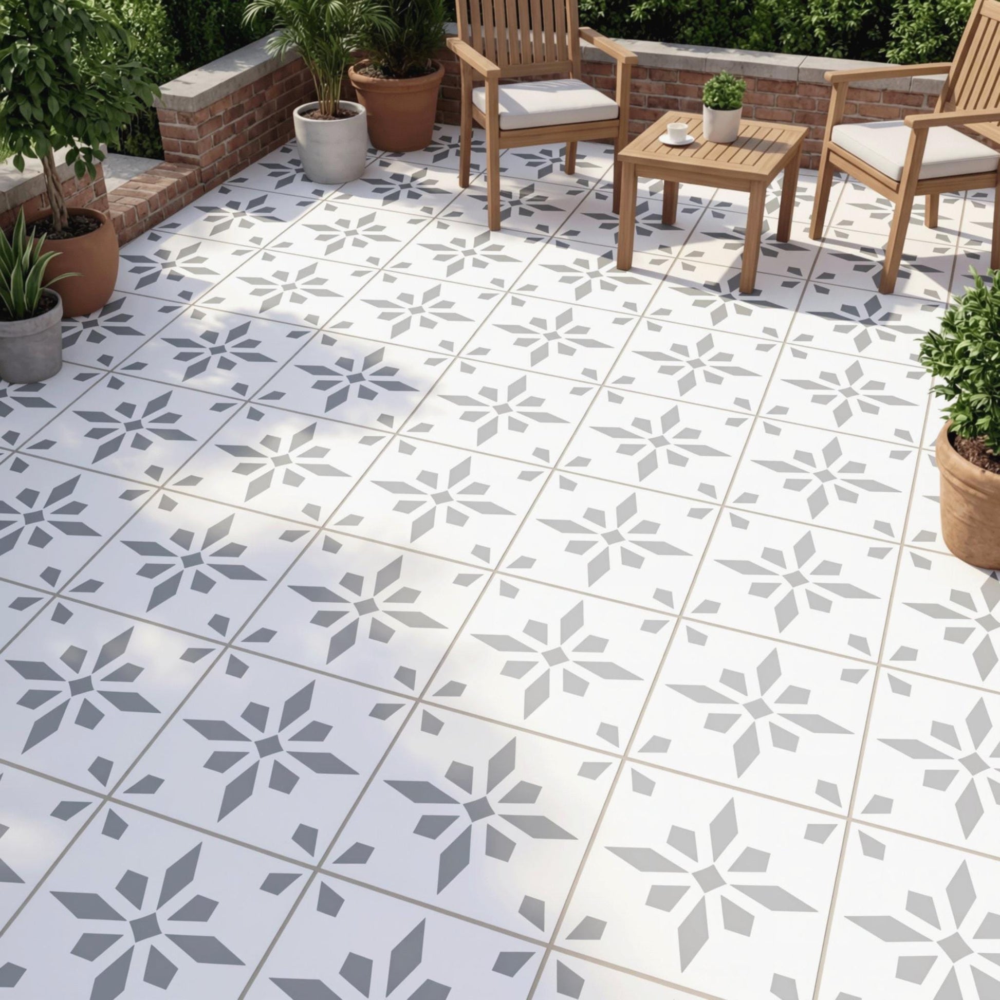 a patio area with a tile floor and wooden furniture, including chairs and a table. The patio is decorated with potted plants and has a brick wall in the background.