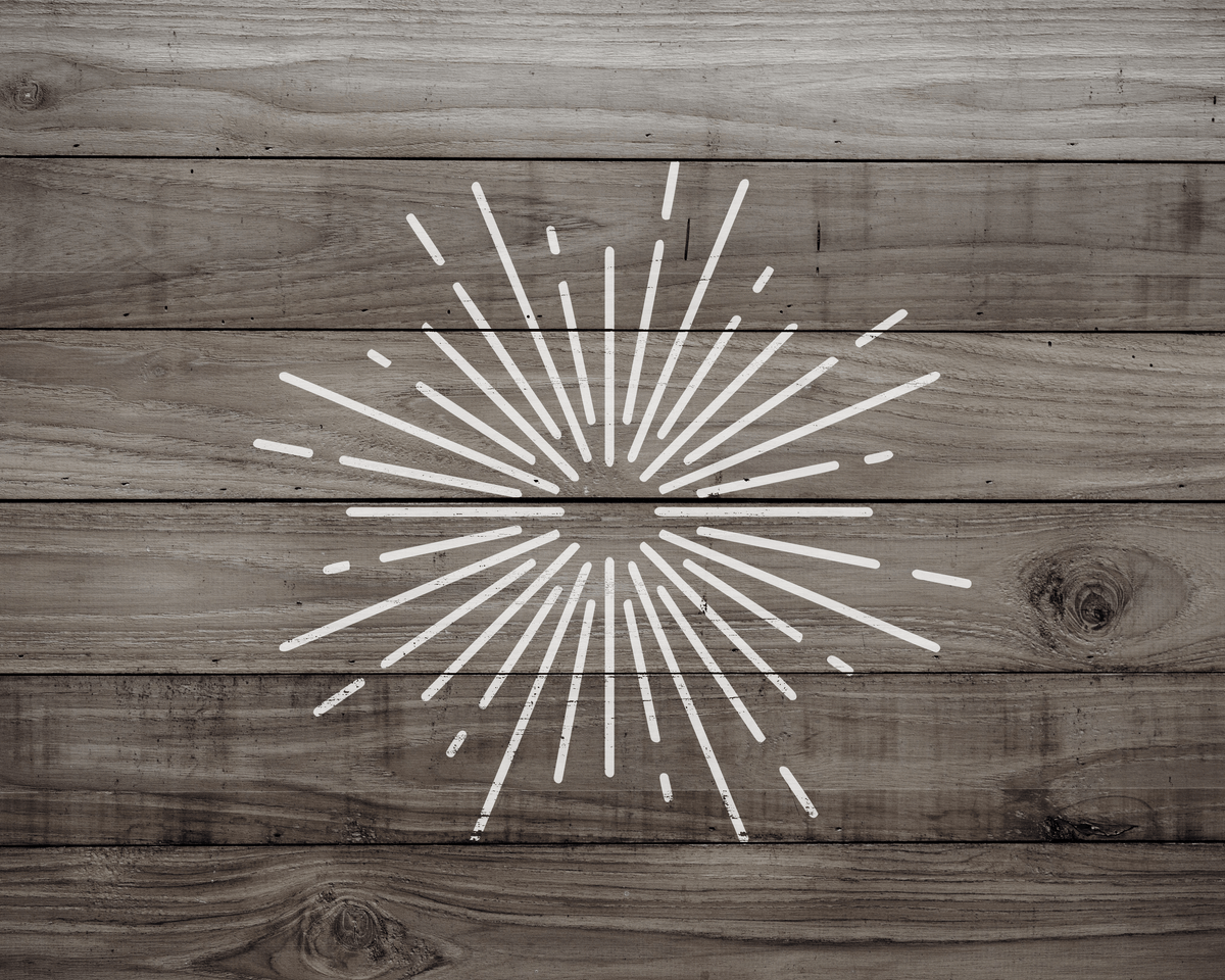 a wooden surface with a white radial line design, resembling a sunburst or burst pattern.