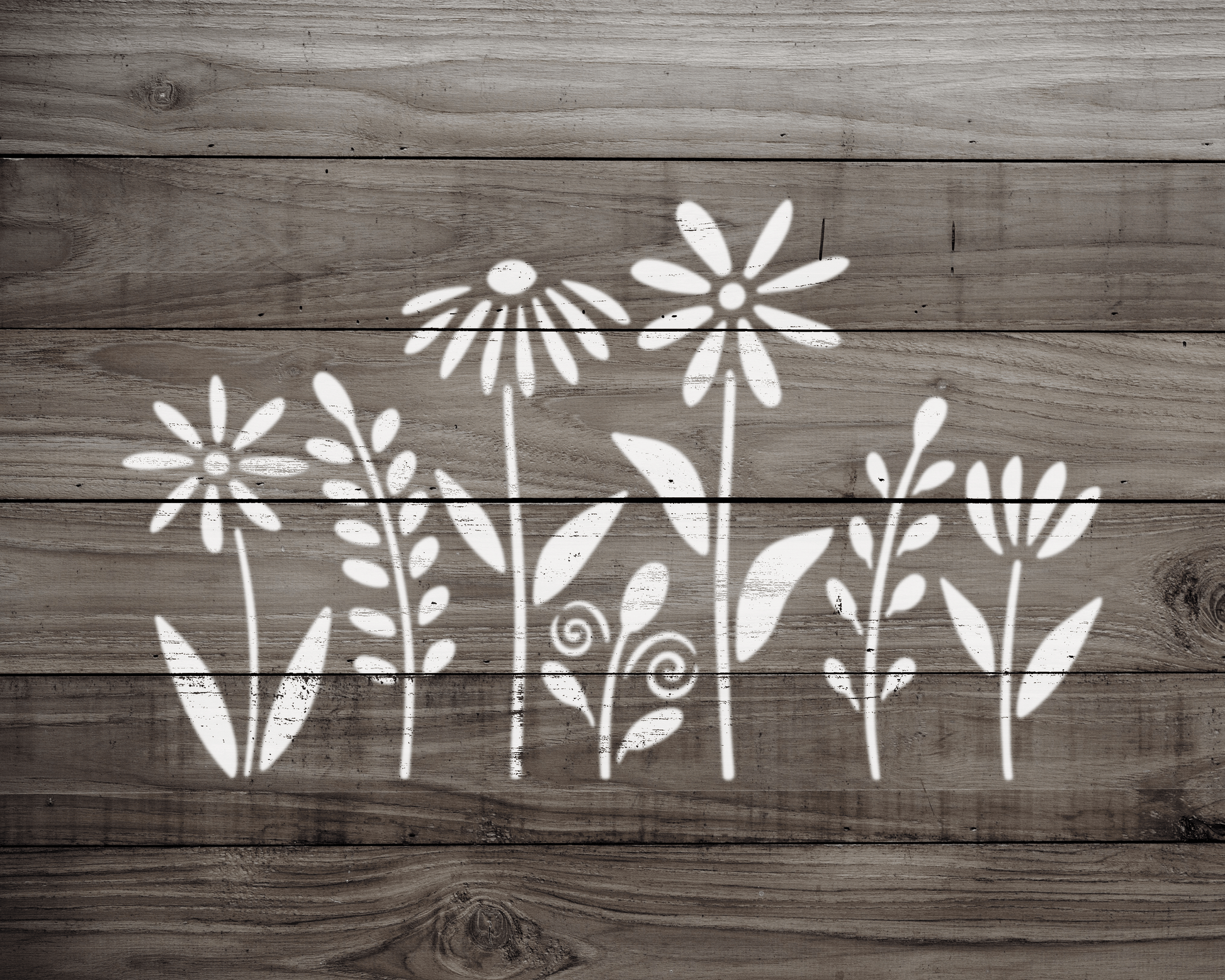 A wooden surface with white floral designs painted on it.