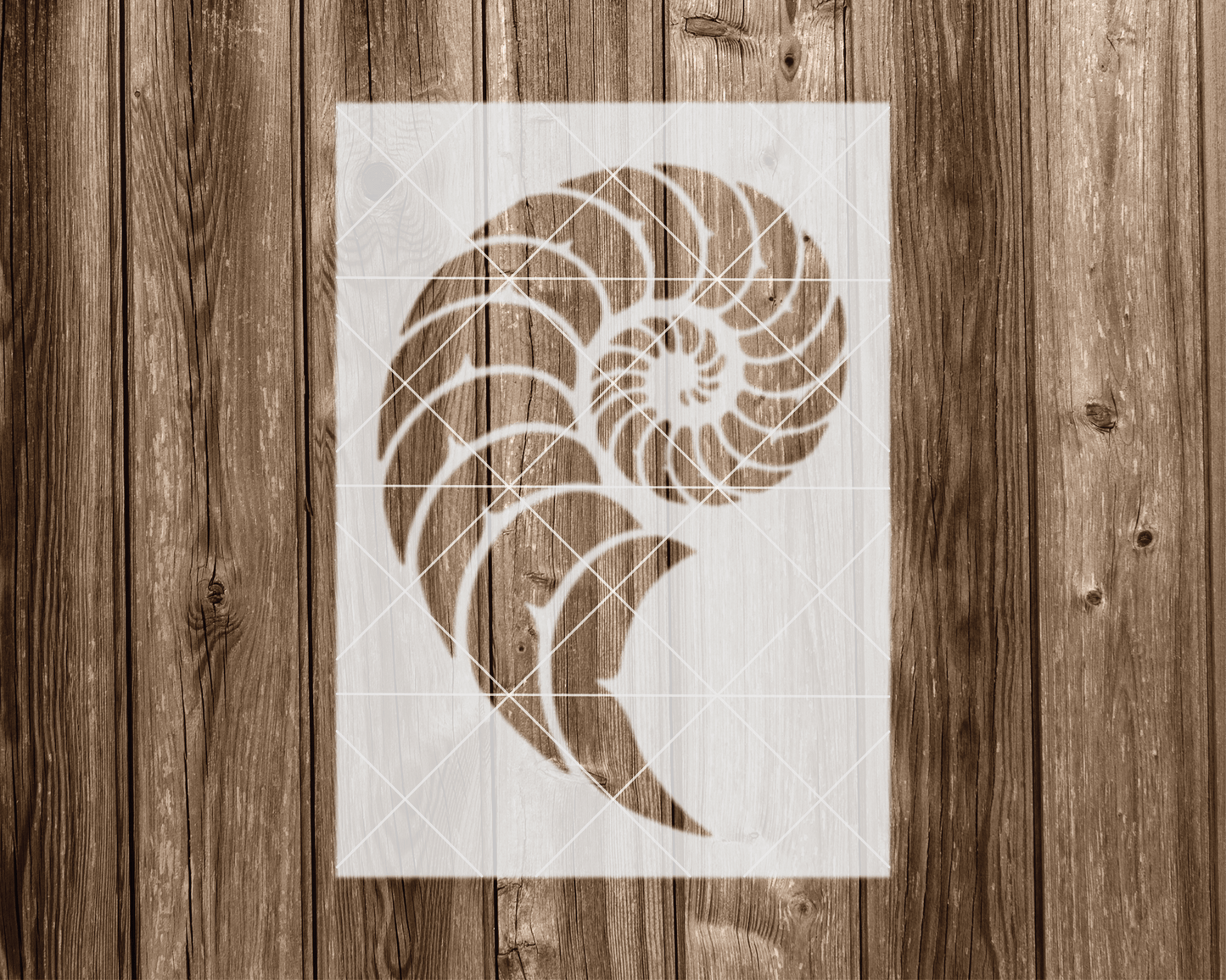 a stencil of a spiral pattern on a wooden background.