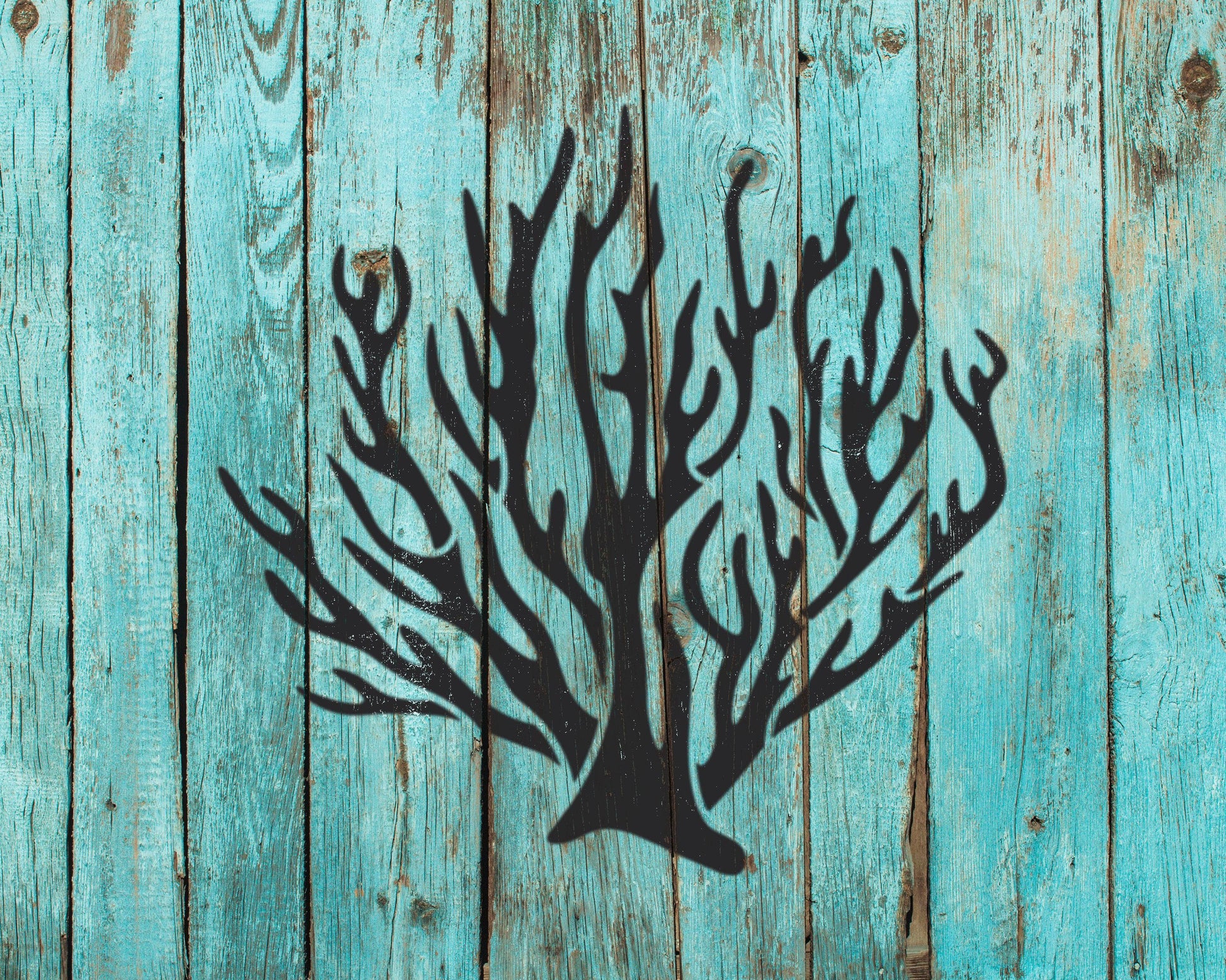 a stylized black tree silhouette against a blue wooden background.