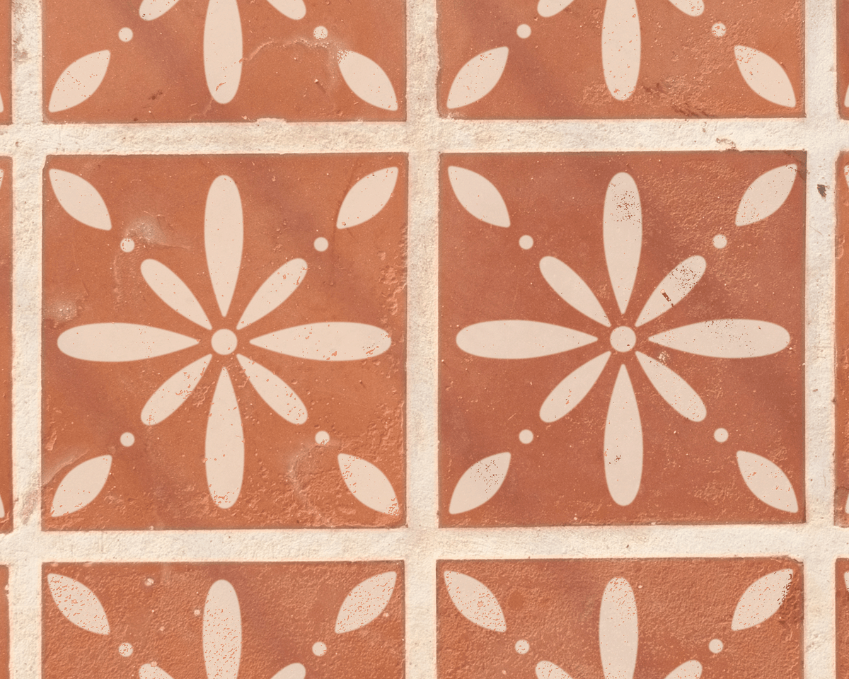a close-up view of a patterned tile surface with a repeating design of white flowers or petals.