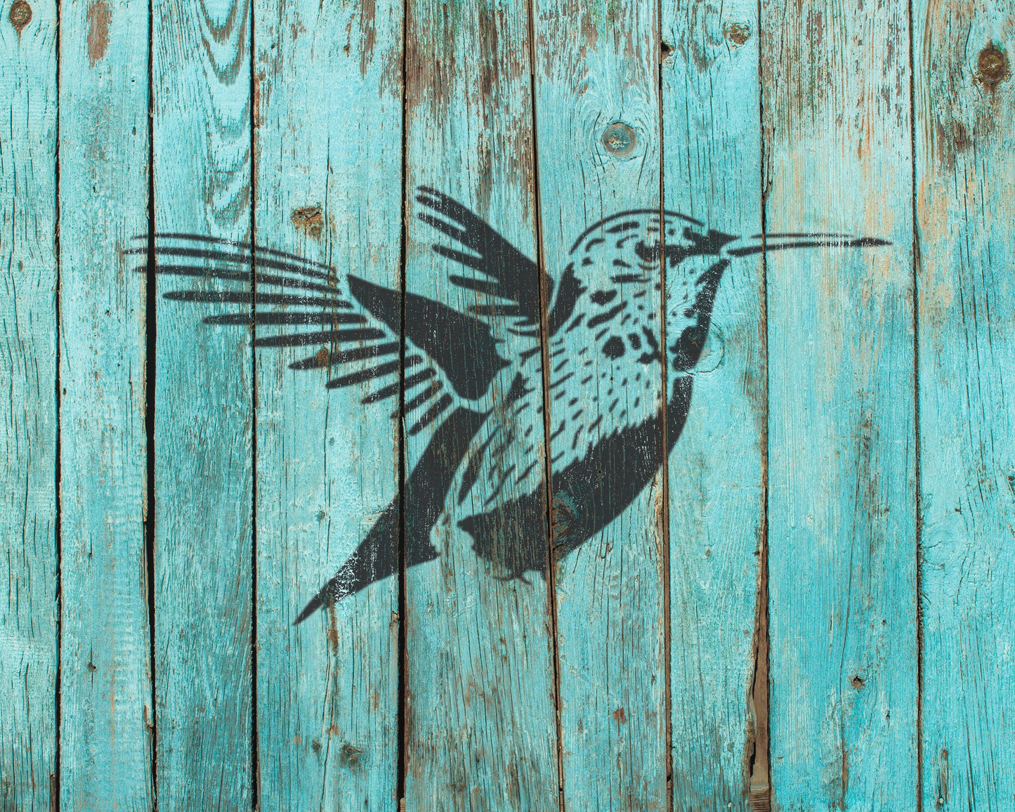 a black silhouette of a bird with outstretched wings against a blue wooden background.