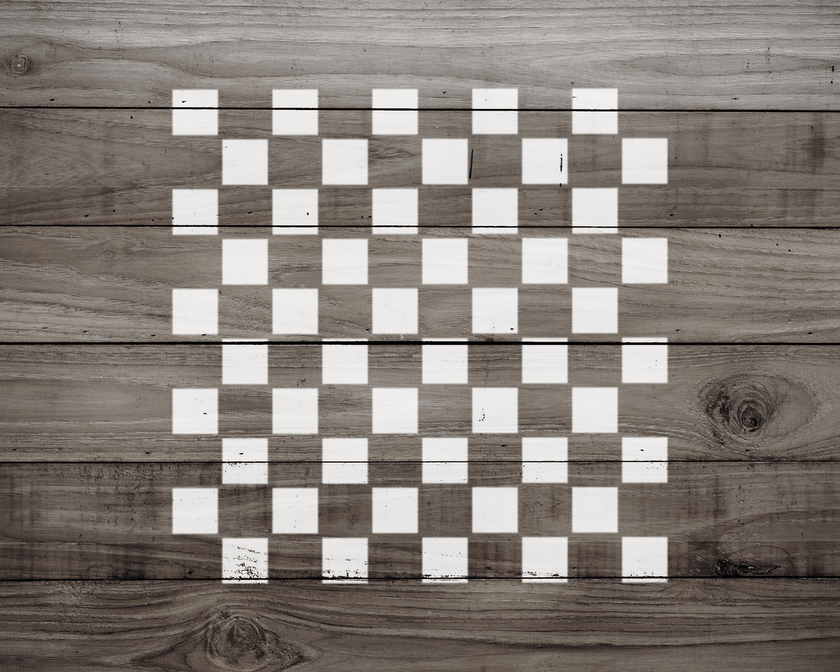 a wooden surface with a checkerboard pattern of white squares.