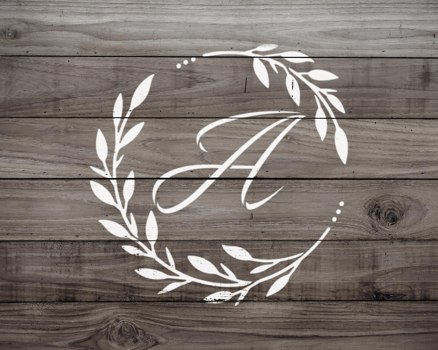 A monogrammed white letter "A" is displayed on a wooden background.