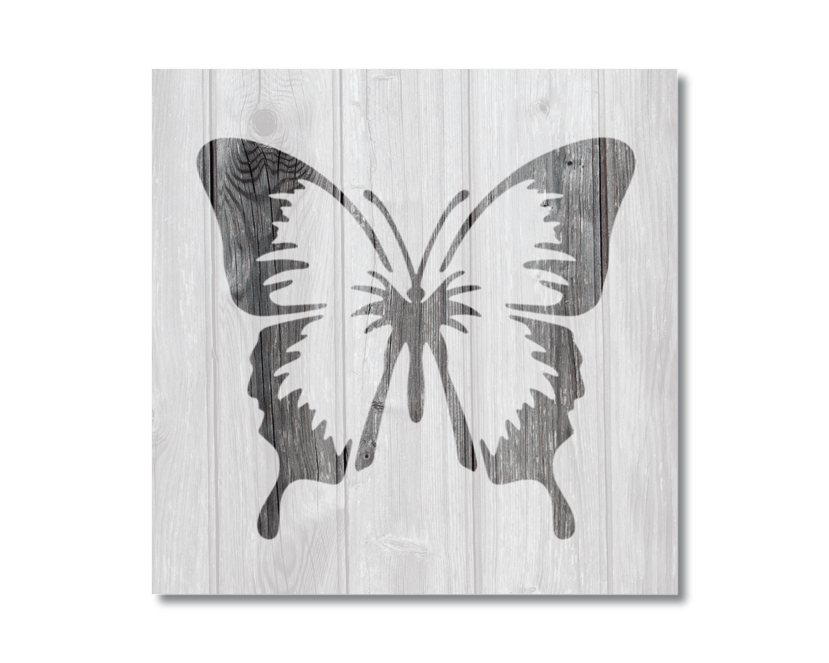A black and white silhouette of a butterfly is displayed on a wooden background.