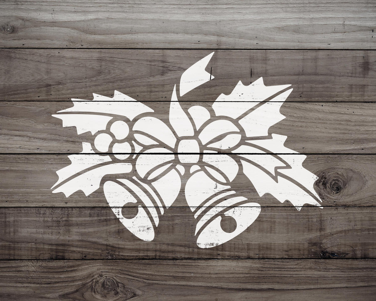 A white silhouette of a Christmas ornament, featuring a bell and holly leaves, is displayed on a wooden background.