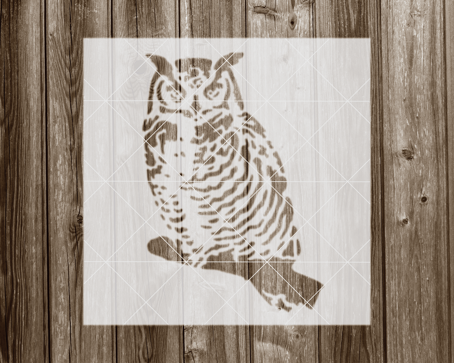 a picture of an owl on a wooden wall