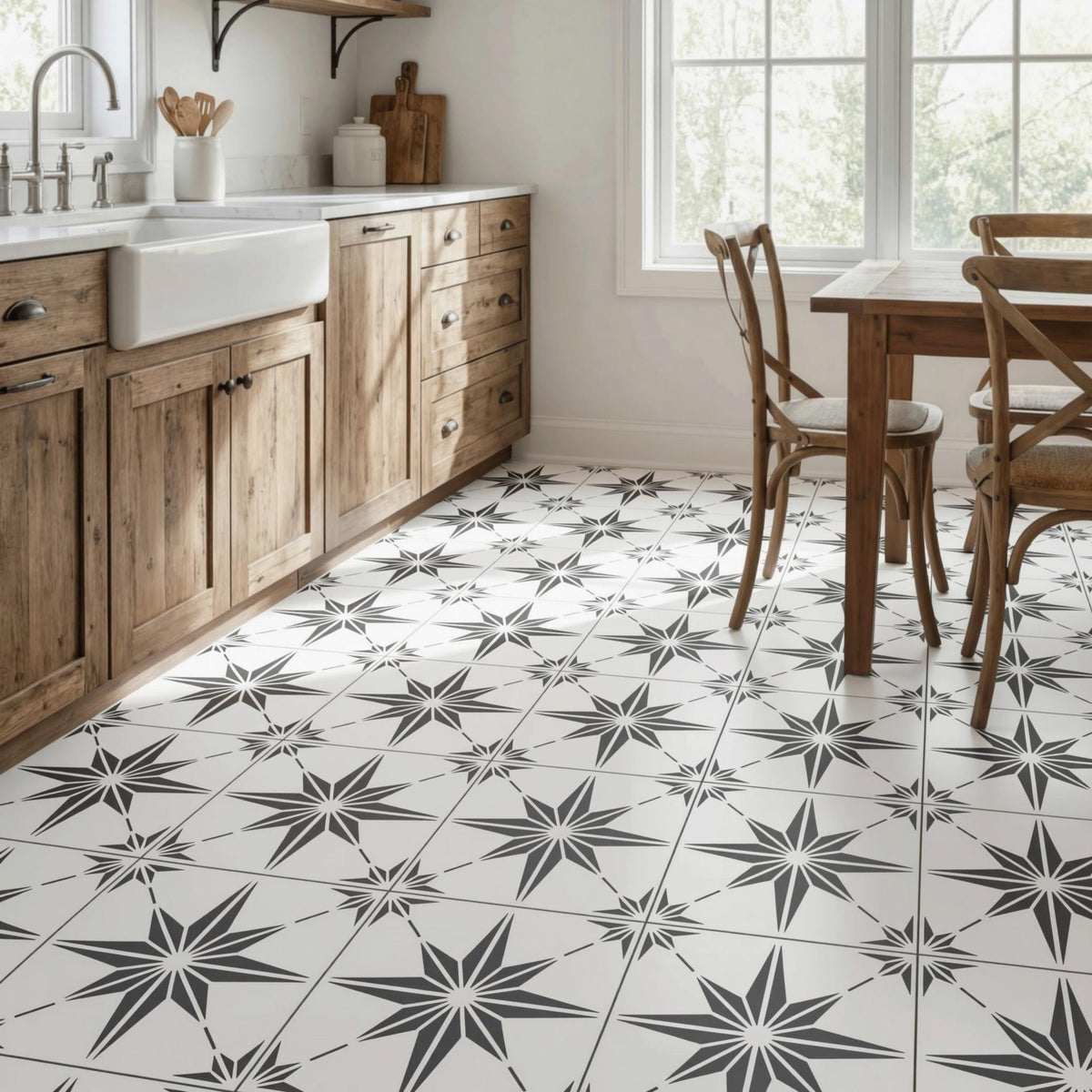 a kitchen with a white tile floor featuring a black star pattern. The kitchen is equipped with wooden cabinets and a sink, and there is a dining table with chairs in the room.