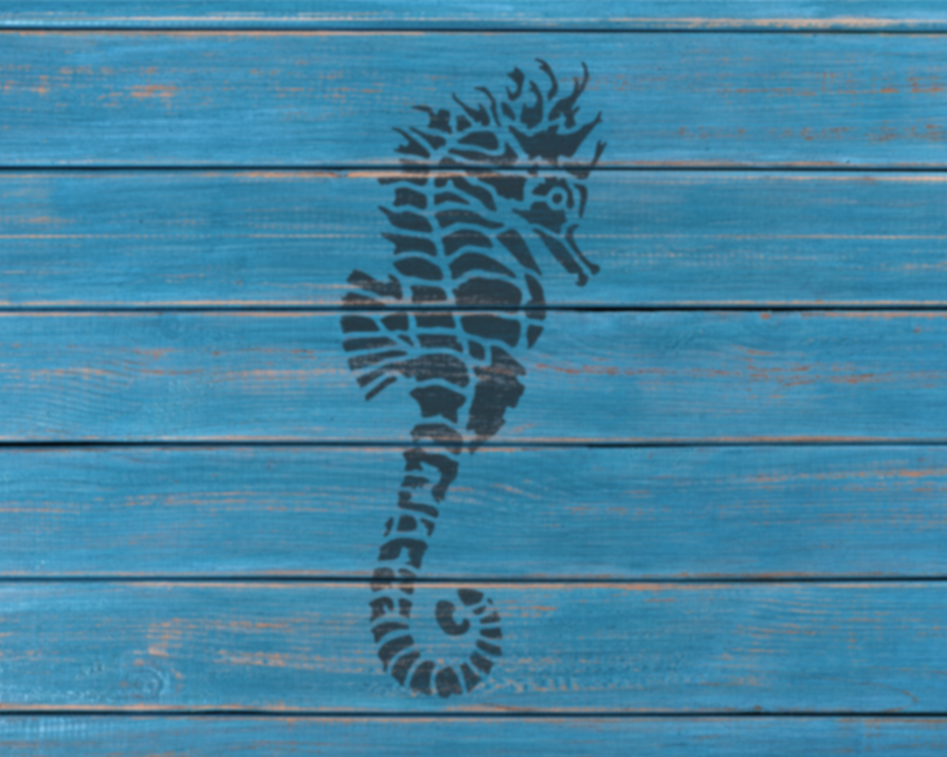 A black silhouette of a seahorse is painted on a blue wooden surface.