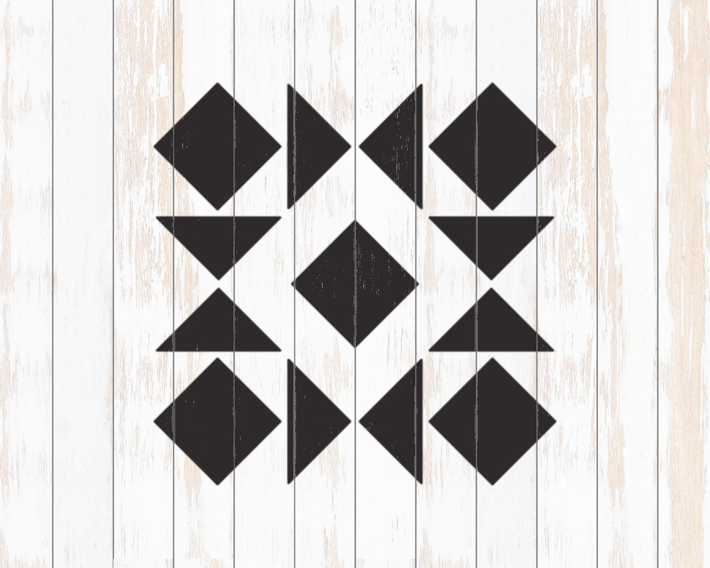 a geometric pattern composed of black triangles arranged in a repeating pattern on a white wooden background.