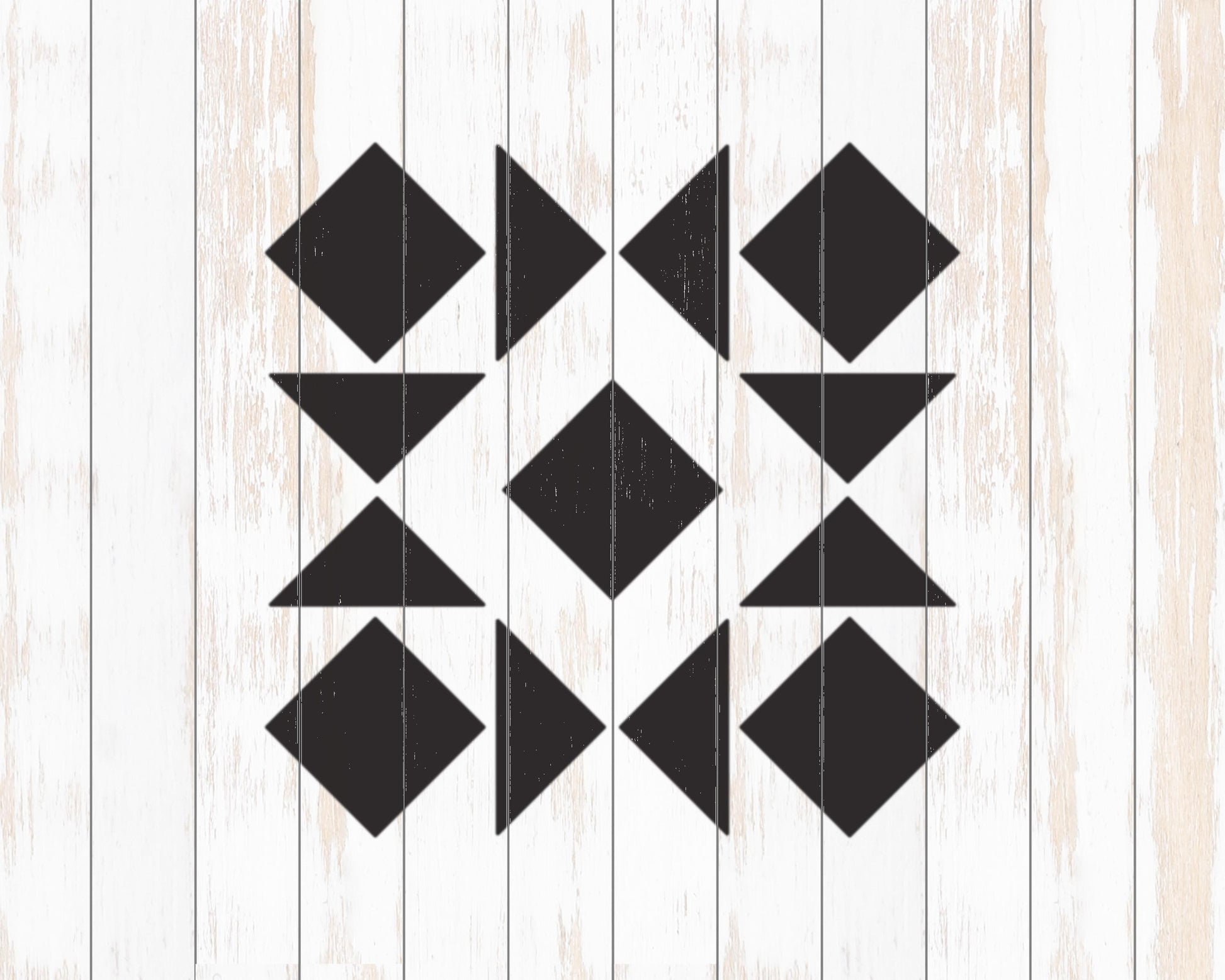 a geometric pattern composed of black triangles arranged in a repeating pattern on a white wooden background.