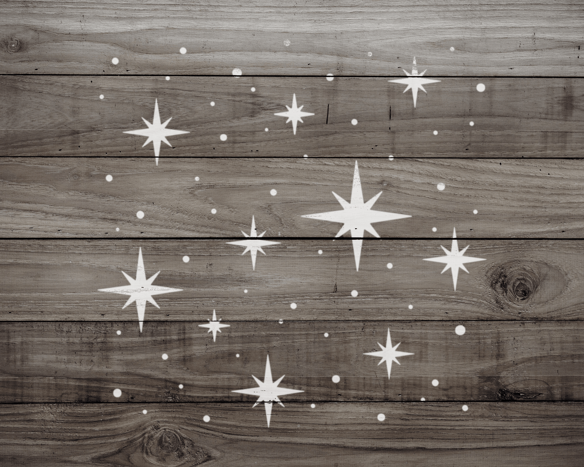a wooden surface with white star-like shapes scattered across it, creating a starry night sky effect.