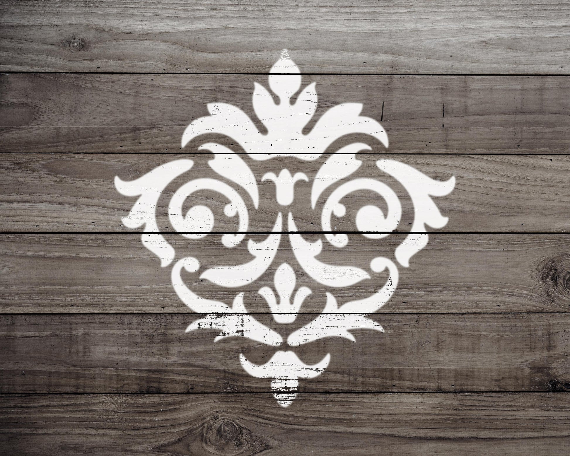 a decorative white pattern painted on a wooden surface.