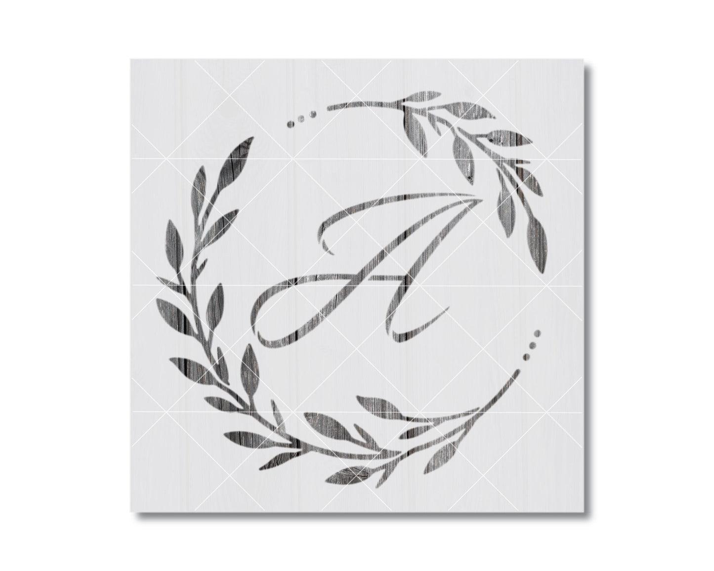 A monogrammed letter "A" surrounded by a decorative wreath of leaves and branches.