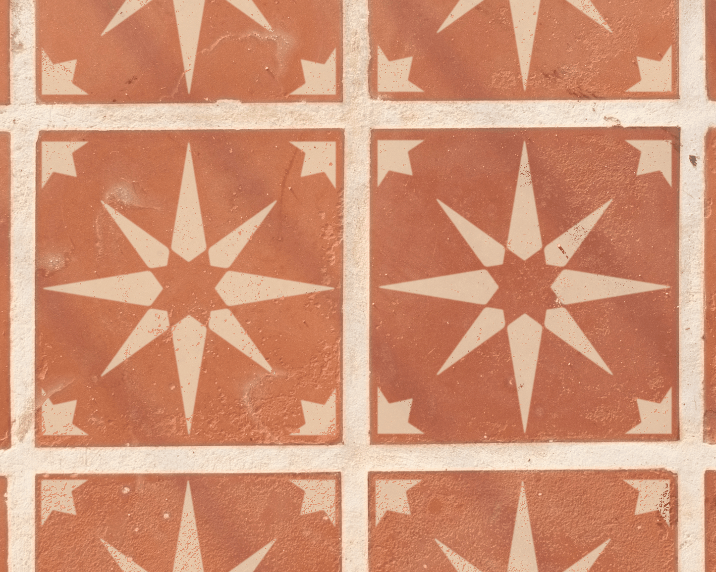 a pattern of red and white star-shaped tiles arranged in a grid-like design.